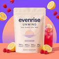 Evenrise Unwind pouch with a glass of raspberry lemon drink